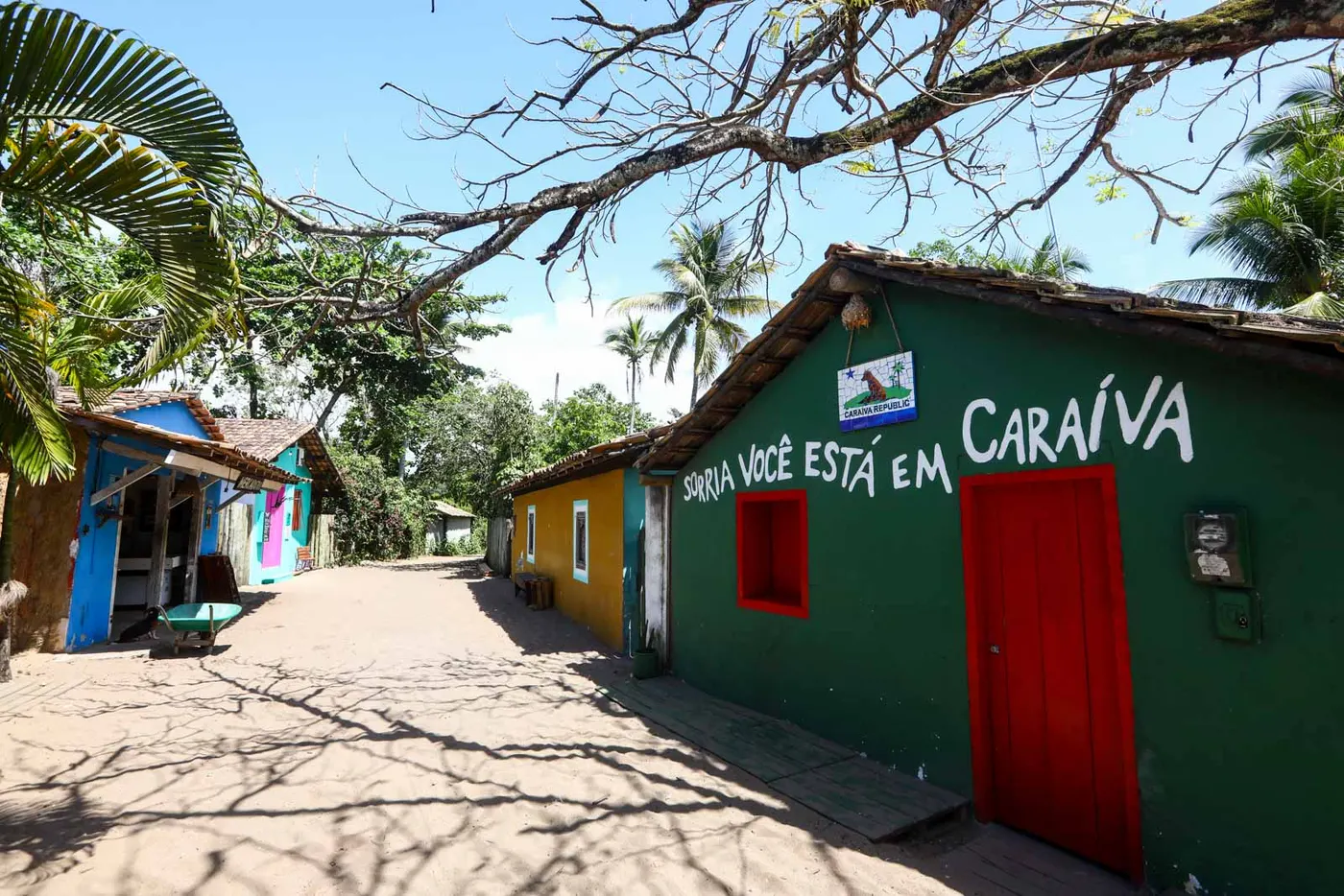 Casas coloridas e rua de areia em Caraíva